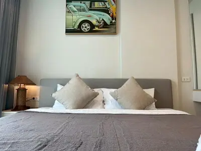 a bedroom with a bed with two cars on the wall at ห้องวิวเขา in Ban Ket Ho
