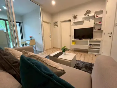 a living room with a couch and a tv at ห้องวิวเขา in Ban Ket Ho