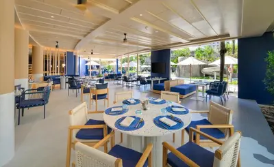 a dining room with a table and chairs at Centara Karon Villas Phuket in Karon Beach