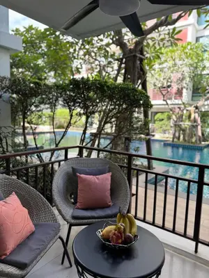 a bowl of fruit sitting on a table on a balcony at Pool Access Beachfront Studio in Phuket Town
