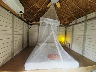 a bed in a room with a ceiling fan at Krabi Sea view, Lilly Beach Room Balibar in Krabi town