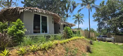 a small house with a thatch roof at Krabi Sea view, Lilly Beach Room Balibar in Krabi town
