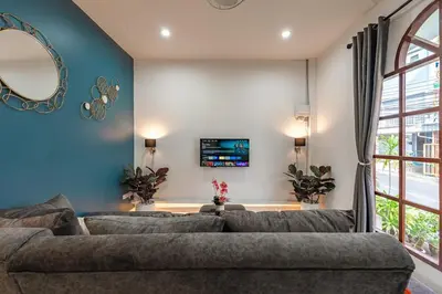 a living room with a couch and a mirror at The Coastal Haven Holiday Home, Karon Beach in Karon Beach