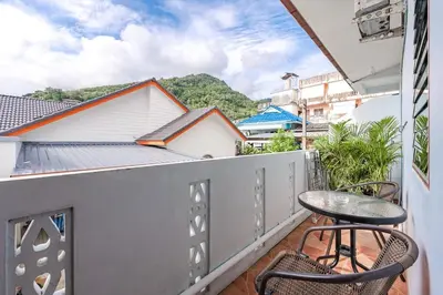 a balcony with two chairs and a table at The Coastal Haven Holiday Home, Karon Beach in Karon Beach