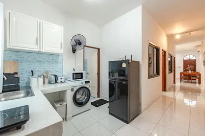 a kitchen with a refrigerator and a counter top at The Coastal Haven Holiday Home, Karon Beach in Karon Beach