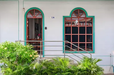 a house with two windows and a balcony at The Coastal Haven Holiday Home, Karon Beach in Karon Beach