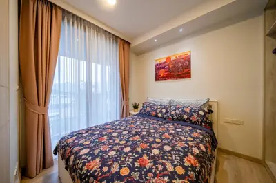 a bedroom with a bed and a large window at Sky park, 2 bed Besthome98 in Laguna Phuket