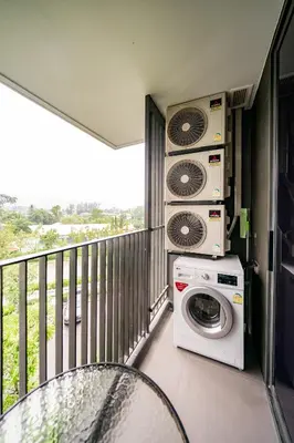 a balcony with a washing machine and a washer at Sky park, 2 bed Besthome98 in Laguna Phuket