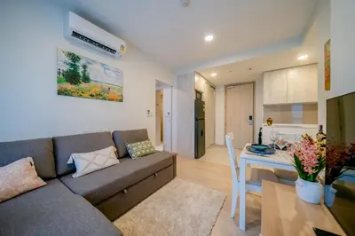 a living room and kitchen with a couch and a table at Sky park, 2 bed Besthome98 in Laguna Phuket