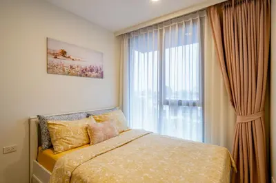 a bedroom with a bed and a large window at Sky park, 2 bed Besthome98 in Laguna Phuket