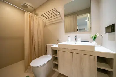 a bathroom with a sink and a toilet and a mirror at Sky park, 2 bed Besthome98 in Laguna Phuket