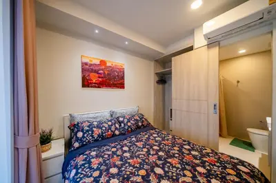 a small bedroom with a bed and a bathroom at Sky park, 2 bed Besthome98 in Laguna Phuket