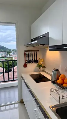 a kitchen with a counter with a sink and a window at Apartment with a view near the park in Ban Rangeng