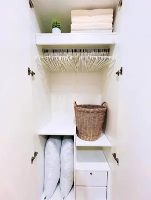 a walk in closet with white shelves and a basket at Apartment with a view near the park in Ban Rangeng