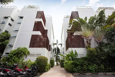 a row of white buildings with motorcycles parked in front at Tranquil 2-Bedroom Getaway - Celeena #870 in Rawai Beach