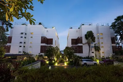a white building with a car parked in front of it at Tranquil 2-Bedroom Getaway - Celeena #870 in Rawai Beach
