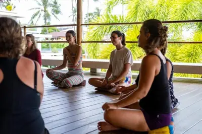 a group of people sitting in a yoga class at Tranquil 2-Bedroom Getaway - Celeena #870 in Rawai Beach