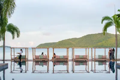 a group of people standing on a dock in the water at Tranquil 2-Bedroom Getaway - Celeena #870 in Rawai Beach