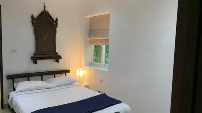 a bedroom with a bed and a clock on the wall at Tranquil 2-Bedroom Getaway - Celeena #870 in Rawai Beach