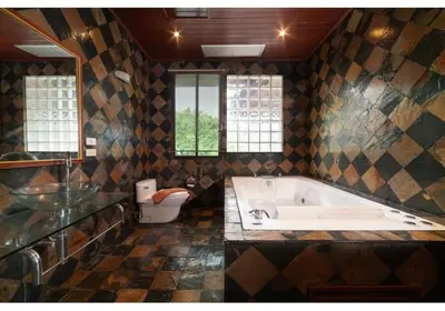 a bathroom with a tub and a toilet and a sink at Lumaya Rawai in Rawai Beach