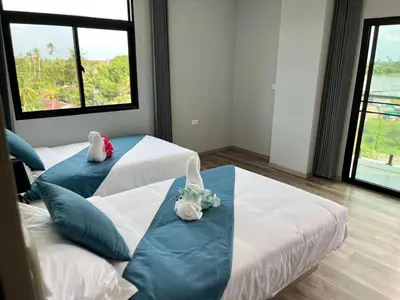 a room with two beds with stuffed animals on them at UPMOON Hotel Chalong Phuket in Ban Suan