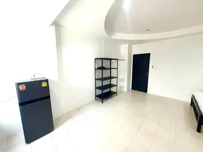 a room with a refrigerator in the corner of a room at Patong Canal Villa 102 in Patong Beach