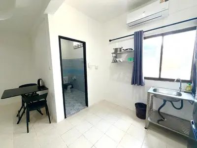 a bathroom with a mirror and a sink and a desk at Patong Canal Villa 102 in Patong Beach