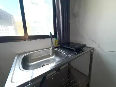 a sink in a kitchen with a window at Patong Canal Villa 102 in Patong Beach