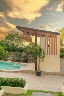 a villa with a swimming pool and a house at Villa Melita 5 bedrooms, hillside location with pool and seaview in Kata Beach