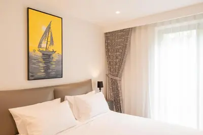 a bedroom with a bed and a sailboat on the wall at Villa Melita 5 bedrooms, hillside location with pool and seaview in Kata Beach