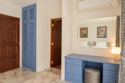 a bedroom with a blue desk and a mirror at Villa Melita 5 bedrooms, hillside location with pool and seaview in Kata Beach
