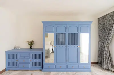 a blue cabinet in a room with a bedroom at Villa Melita 5 bedrooms, hillside location with pool and seaview in Kata Beach