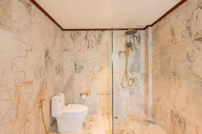 a bathroom with a toilet and a shower at Villa Melita 5 bedrooms, hillside location with pool and seaview in Kata Beach