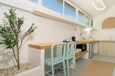 a kitchen with a table and two chairs and a tree at Loft with pool & patio - 8 min to Rawai beach - 