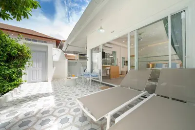 a white patio with chairs and a table at Loft with pool & patio - 8 min to Rawai beach - 