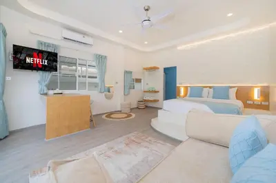 a bedroom with a bed and a tv and a couch at Loft with pool & patio - 8 min to Rawai beach - 