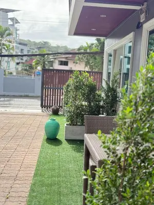 a yard with two benches and a green vase at Jungle style apartments in Kamala in Kamala Beach