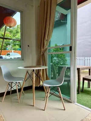 a table and chairs in a room with a window at Jungle style apartments in Kamala in Kamala Beach