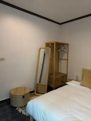 a bedroom with a bed and a mirror on the wall at Jungle style apartments in Kamala in Kamala Beach
