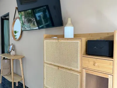 a wooden cabinet with a television on top of it at Jungle style apartments in Kamala in Kamala Beach