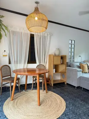 a living room with a table and a couch at Jungle style apartments in Kamala in Kamala Beach