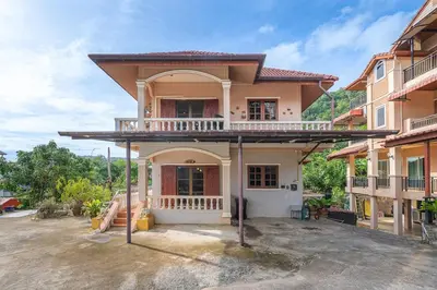 a house with a balcony on top of it at Serenity Holiday Villa 1 D Karon Beach in Karon Beach