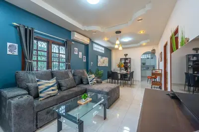 a living room with a couch and a table at Serenity Holiday Villa 1 D Karon Beach in Karon Beach