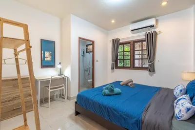 a bedroom with a blue bed and a ladder at Serenity Holiday Villa 1 D Karon Beach in Karon Beach