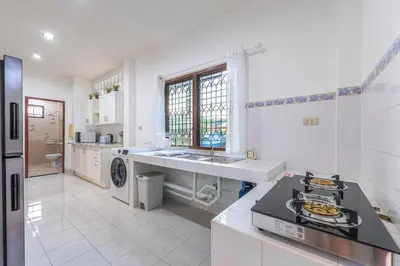 a white kitchen with a sink and a stove at Serenity Holiday Villa 1 D Karon Beach in Karon Beach