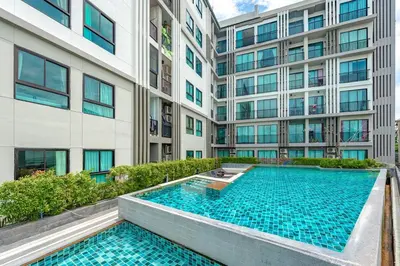 an exterior view of a building with a swimming pool at C232 Prime spot Pool Gym Near Beach&Boat Ave in Bang Tao Beach