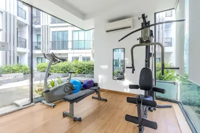 a gym with exercise equipment in a building at C232 Prime spot Pool Gym Near Beach&Boat Ave in Bang Tao Beach