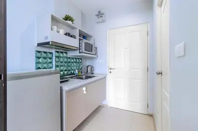 a white kitchen with a sink and a white door at C232 Prime spot Pool Gym Near Beach&Boat Ave in Bang Tao Beach
