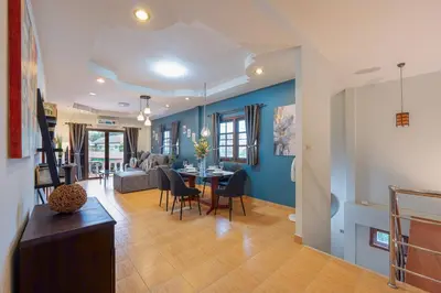 a living room and dining room with a table and chairs at Serenity Holiday Villa 2, Karon Beach in Karon Beach