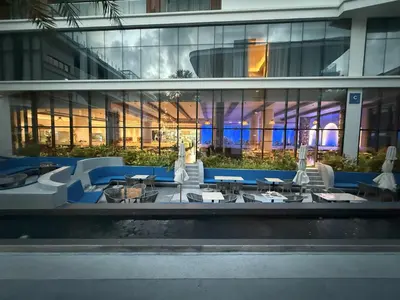 a view of a building with tables and chairs at The Sunshine Beach 3-bedrooms Suite with Pool in Layan Beach